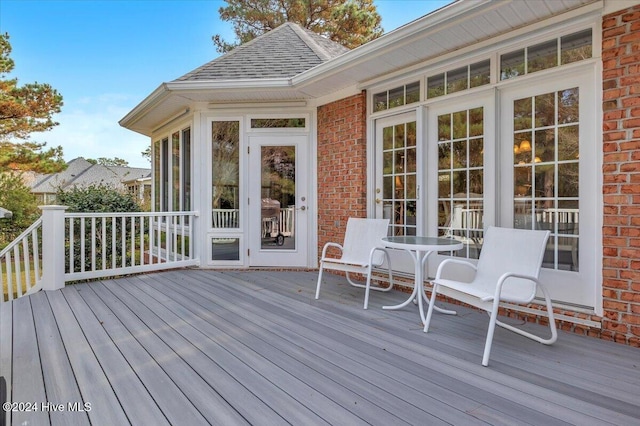 wooden deck with a sunroom