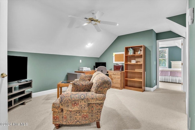 living area featuring ceiling fan, light carpet, and vaulted ceiling