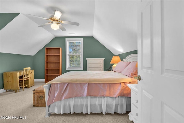 carpeted bedroom with ceiling fan and vaulted ceiling