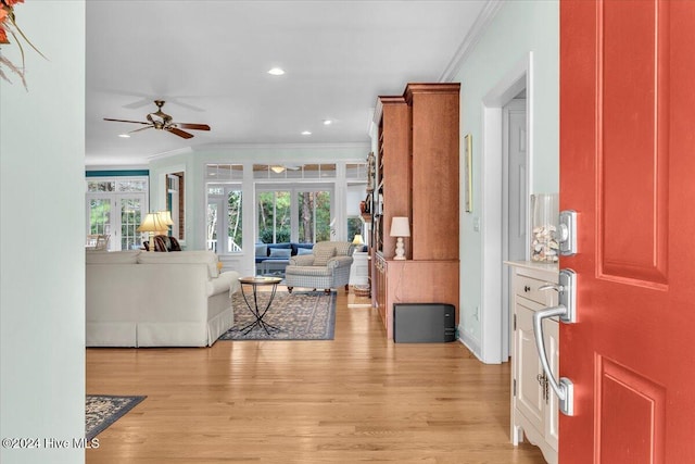 interior space with ceiling fan, light hardwood / wood-style flooring, and crown molding