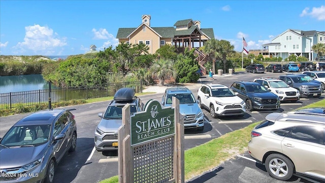 view of parking / parking lot with a water view