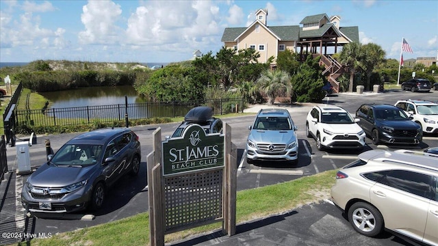 view of parking / parking lot featuring a water view