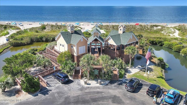 drone / aerial view featuring a water view and a view of the beach