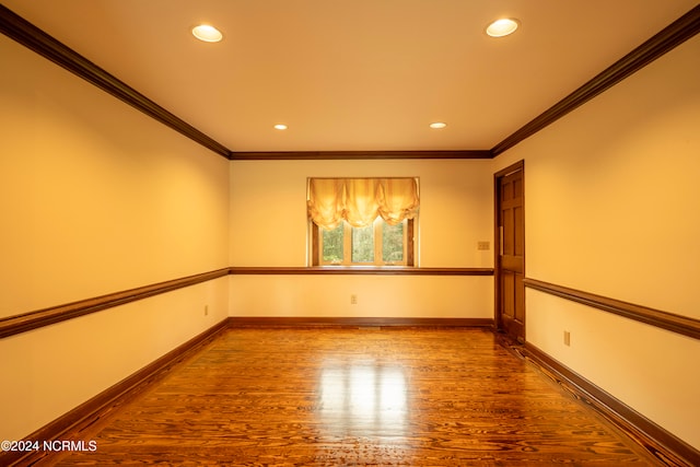 unfurnished room featuring crown molding and wood-type flooring