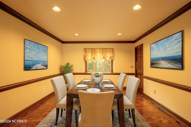 dining space featuring ornamental molding and hardwood / wood-style floors