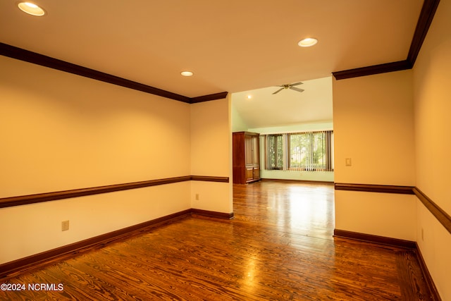 empty room with ceiling fan, wood-type flooring, and ornamental molding