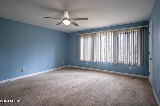 empty room with carpet flooring and ceiling fan