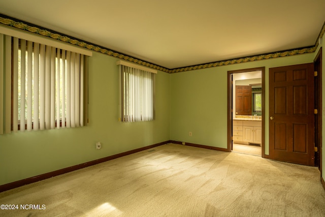 carpeted spare room featuring a healthy amount of sunlight