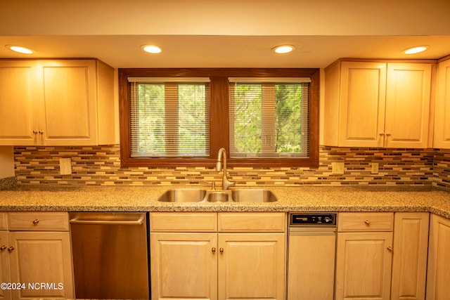 kitchen with dishwasher, tasteful backsplash, sink, and a wealth of natural light