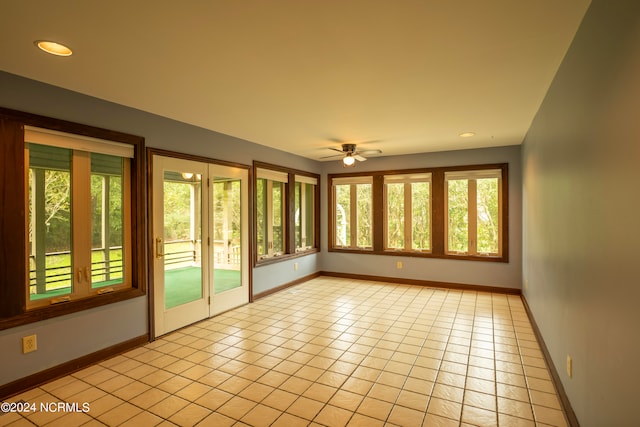 unfurnished sunroom with plenty of natural light and ceiling fan