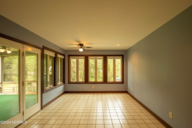 unfurnished sunroom featuring ceiling fan