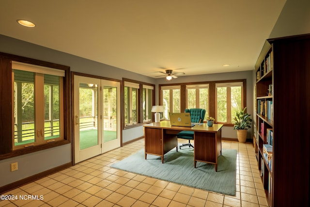 tiled office space with a healthy amount of sunlight and ceiling fan