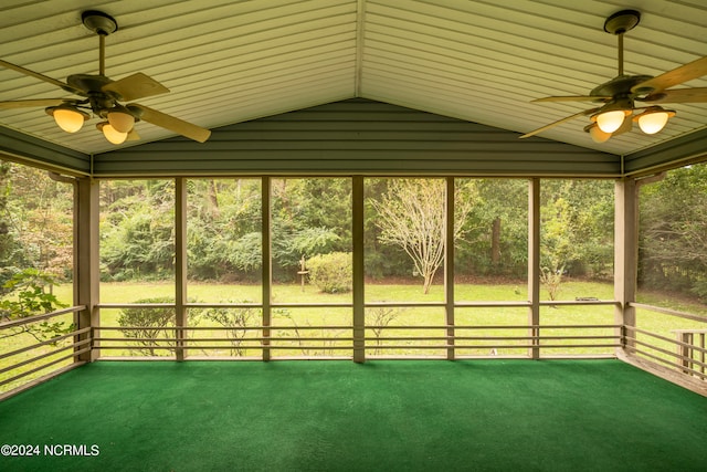 unfurnished sunroom featuring ceiling fan, plenty of natural light, and vaulted ceiling