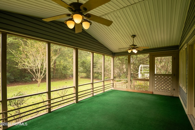 unfurnished sunroom with ceiling fan and vaulted ceiling