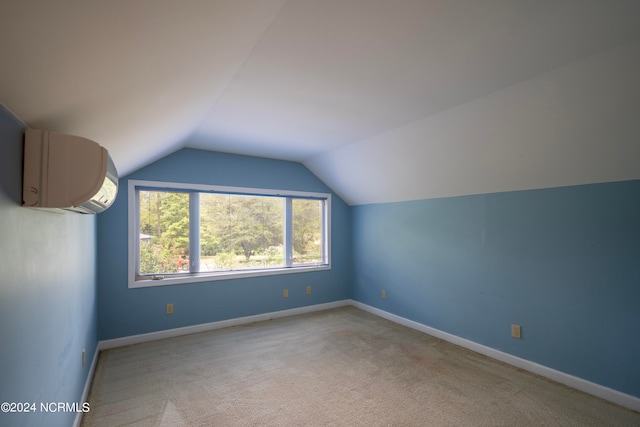 bonus room featuring a wall unit AC, lofted ceiling, and light colored carpet