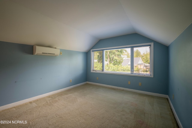 additional living space featuring vaulted ceiling, a wall mounted air conditioner, and light colored carpet