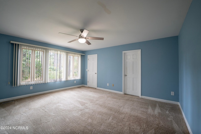 empty room featuring light carpet and ceiling fan