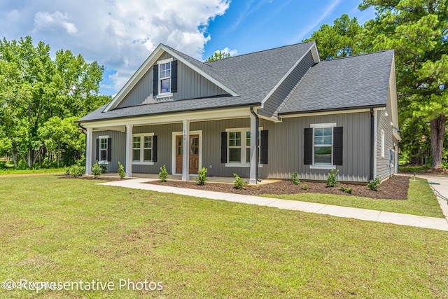 view of front of house with covered porch and a front yard