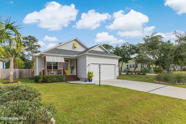 view of front of house with a porch, a garage, and a front lawn