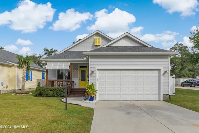 view of front of house featuring a garage and a front lawn