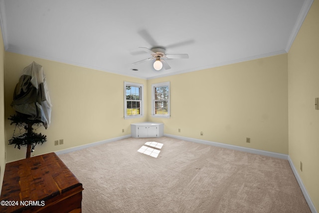 interior space with ceiling fan and crown molding