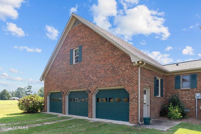 view of home's exterior featuring a garage and a lawn