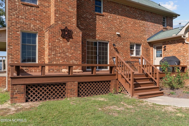 back of property with a yard and a wooden deck