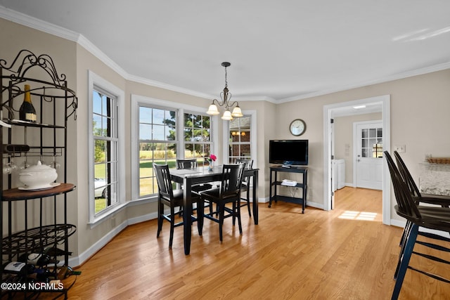 dining room with ornamental molding, an inviting chandelier, and light hardwood / wood-style flooring