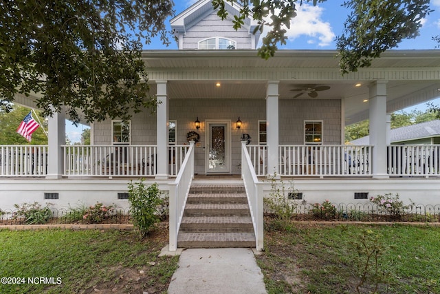 entrance to property with ceiling fan and covered porch