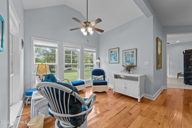 sitting room featuring light hardwood / wood-style floors, vaulted ceiling, and ceiling fan