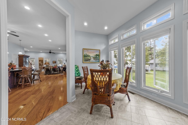 dining room with ceiling fan, light wood-type flooring, and a wealth of natural light