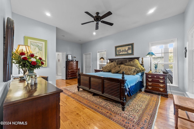 bedroom with light hardwood / wood-style floors and ceiling fan