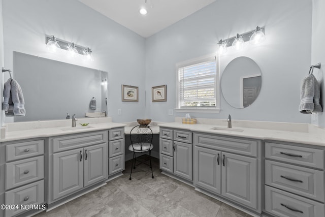 bathroom featuring lofted ceiling and vanity