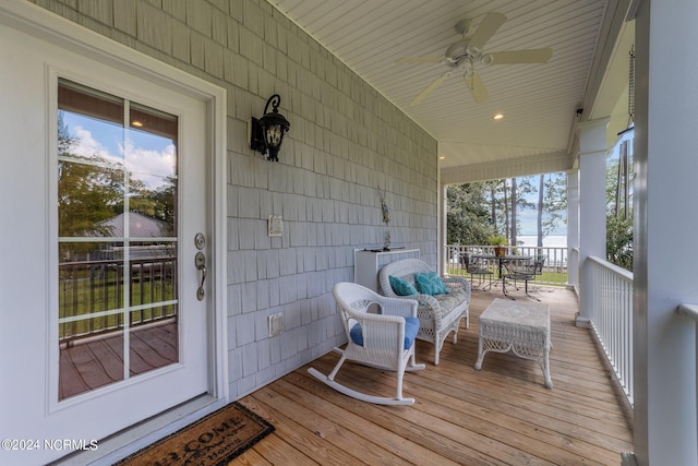 wooden terrace featuring a porch and a ceiling fan