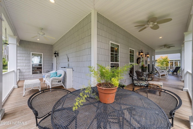 view of patio featuring an outdoor living space, a porch, a ceiling fan, and outdoor dining space