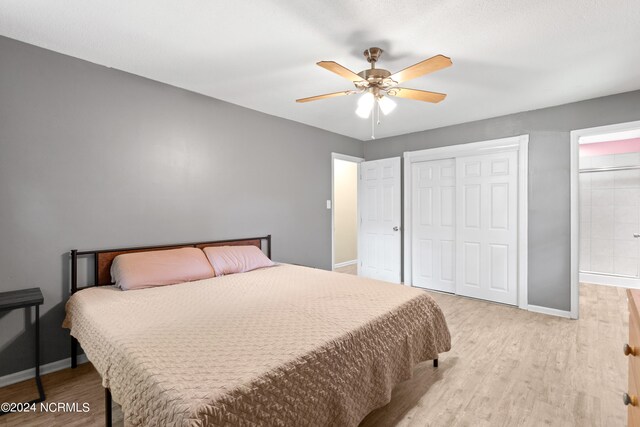 bedroom featuring a closet, light hardwood / wood-style floors, and ceiling fan