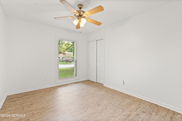 spare room with light wood-type flooring and ceiling fan