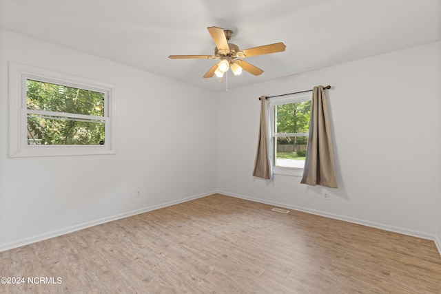 unfurnished room featuring light hardwood / wood-style floors and ceiling fan