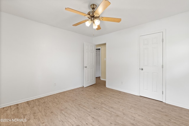 empty room featuring ceiling fan and light wood-type flooring