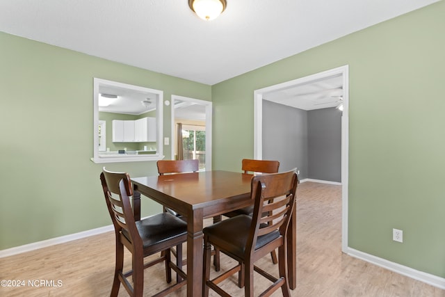 dining room featuring light hardwood / wood-style flooring and ceiling fan