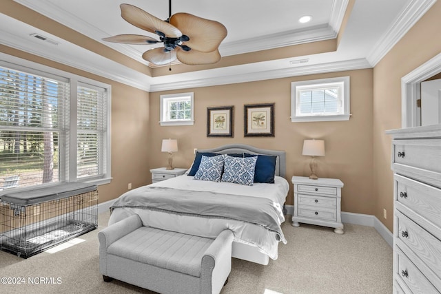 bedroom with a tray ceiling, ornamental molding, ceiling fan, and light carpet