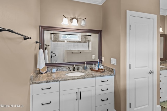 bathroom with vanity, ornamental molding, and an enclosed shower