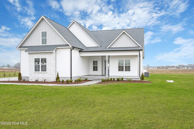 rear view of property with a yard