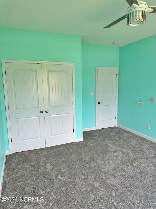 unfurnished bedroom featuring carpet, ceiling fan, and a closet