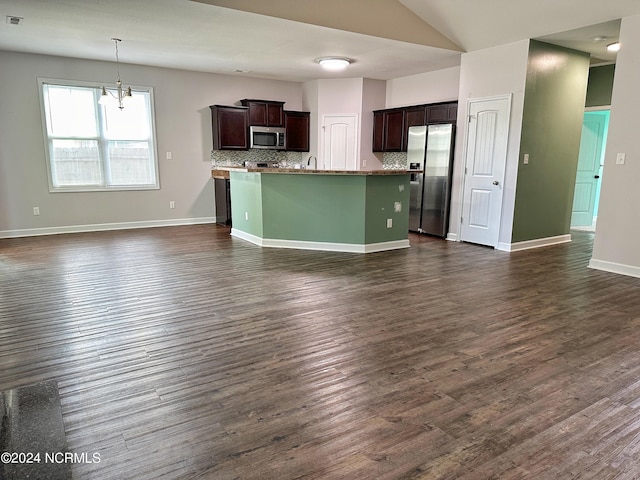 kitchen featuring hanging light fixtures, backsplash, dark hardwood / wood-style flooring, stainless steel appliances, and dark brown cabinets