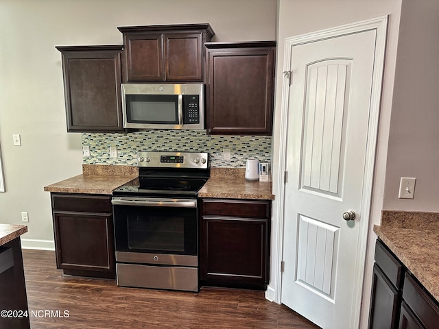 kitchen with dark brown cabinetry, appliances with stainless steel finishes, dark hardwood / wood-style flooring, and tasteful backsplash