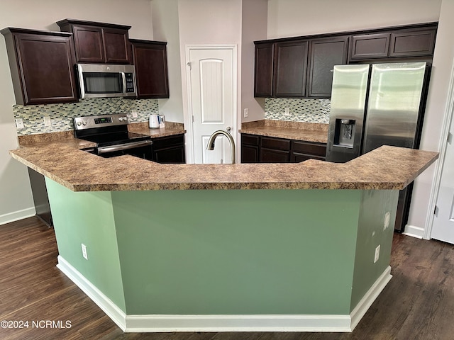 kitchen with decorative backsplash, dark brown cabinets, and stainless steel appliances