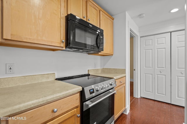 kitchen featuring light brown cabinetry, electric stove, and dark wood-type flooring