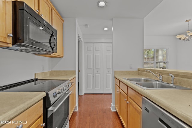 kitchen featuring a chandelier, sink, light hardwood / wood-style flooring, light brown cabinets, and appliances with stainless steel finishes