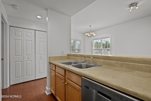 kitchen with pendant lighting, sink, dishwasher, a notable chandelier, and dark hardwood / wood-style flooring